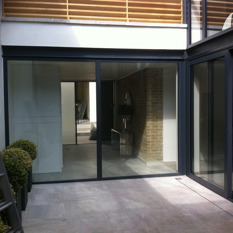 Floor-to-ceiling sliding doors opening to courtyard in Bletchley